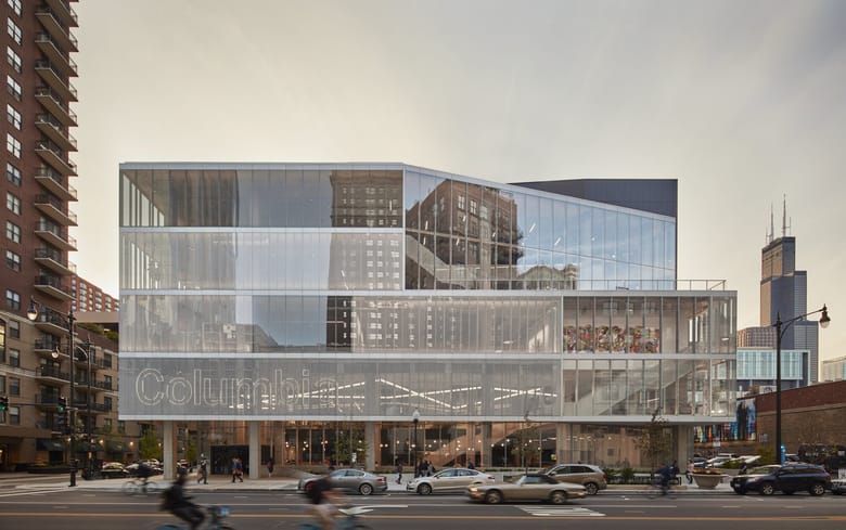 Image of a large glass angular building that is multiple stories.