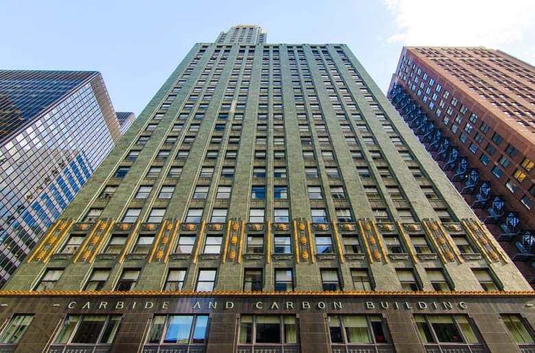 View of a green building from below with a sign that reads in gold "Carbide and Carbon Building" 