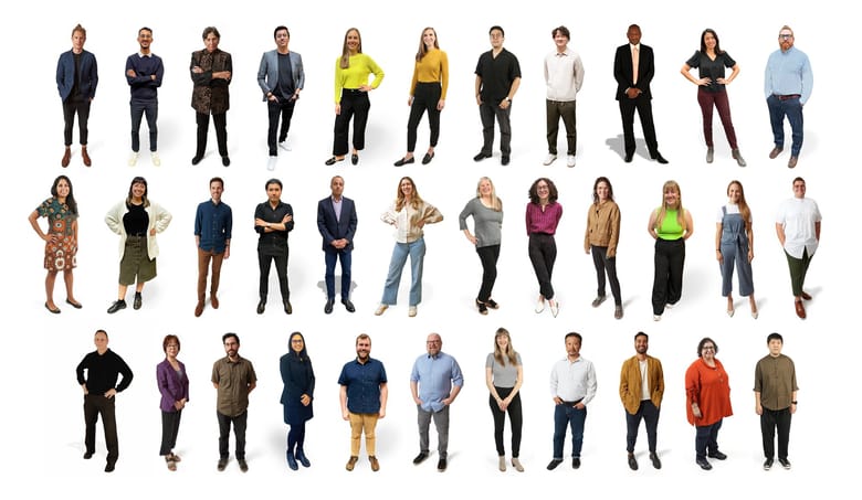 Group of adults standing in stairwell. 
