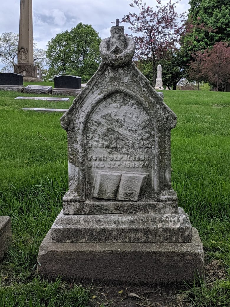 A photo of a worn headstone marking the Grave of Juliette Kinzie
