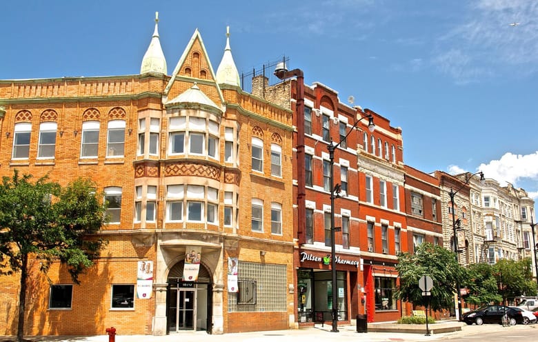 View of city buildings from perspective of street corner