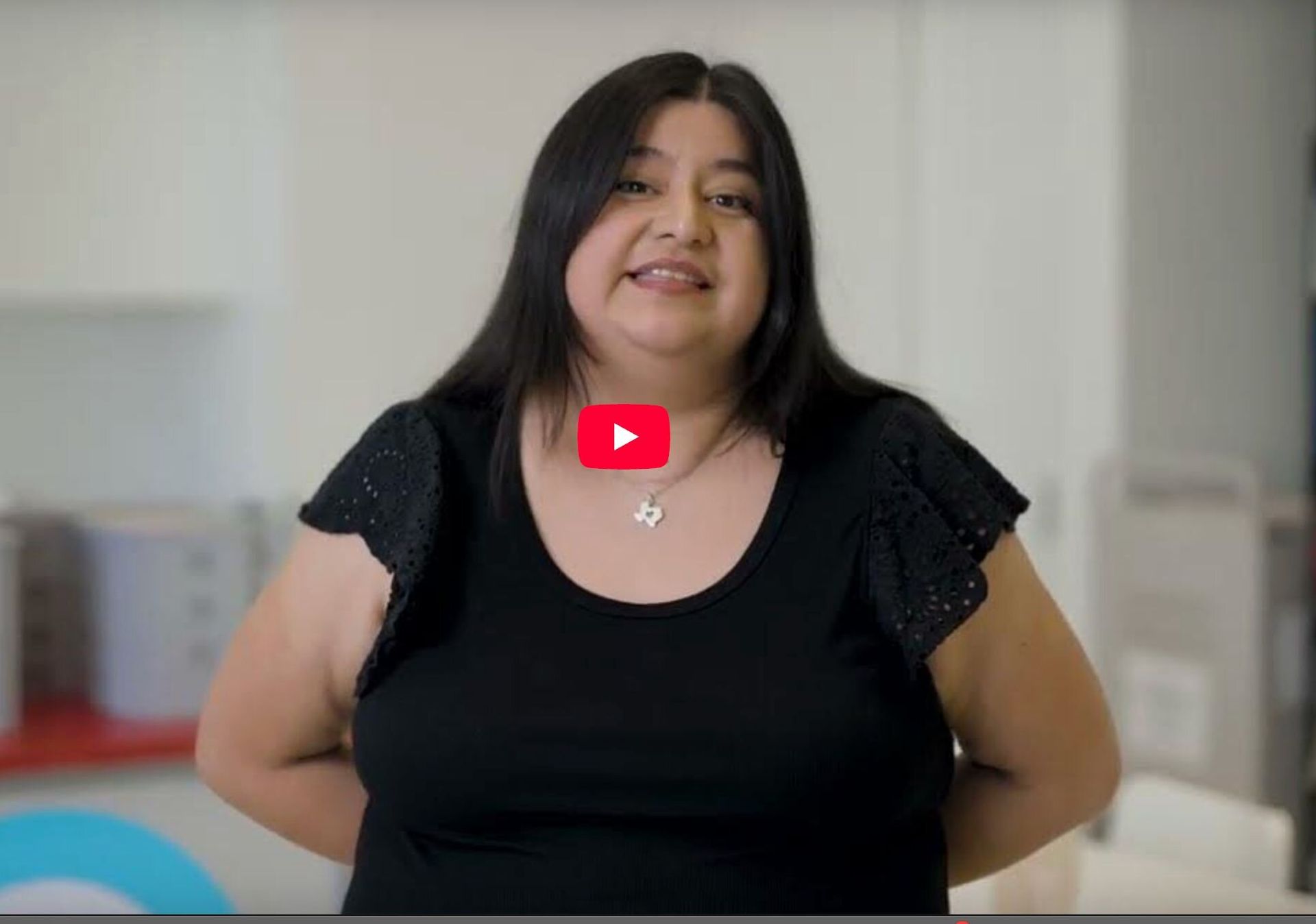 screenshot of a video with a woman with dark hair wearing a black shirt