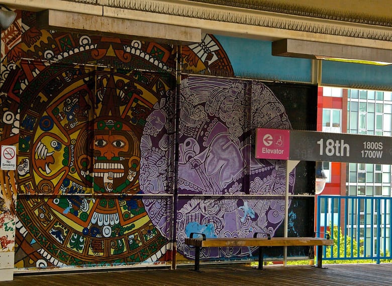 Mural at city train station with large circular art.