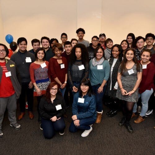 A group of teens, each with name tag smiling