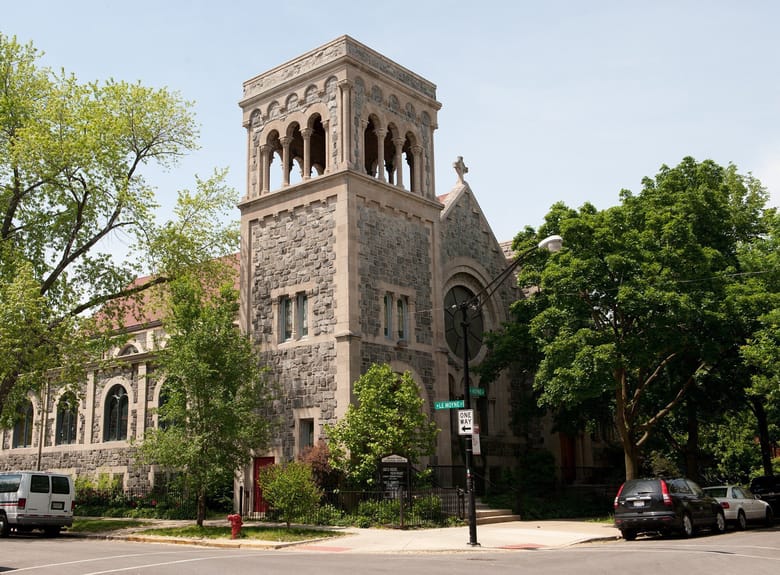 Exterior view of a stone church on a sunny day