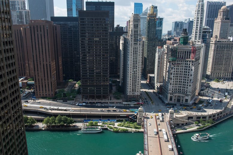 Image of a tall black rectangular building on the river. 