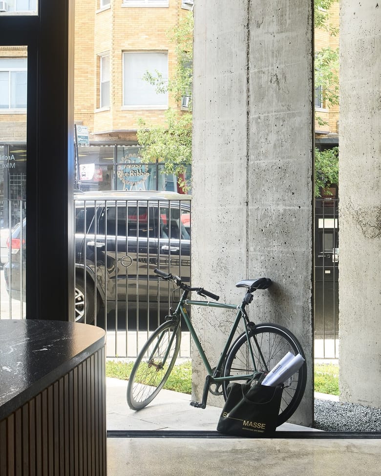 Bicycle leaning against a concrete wall of a building