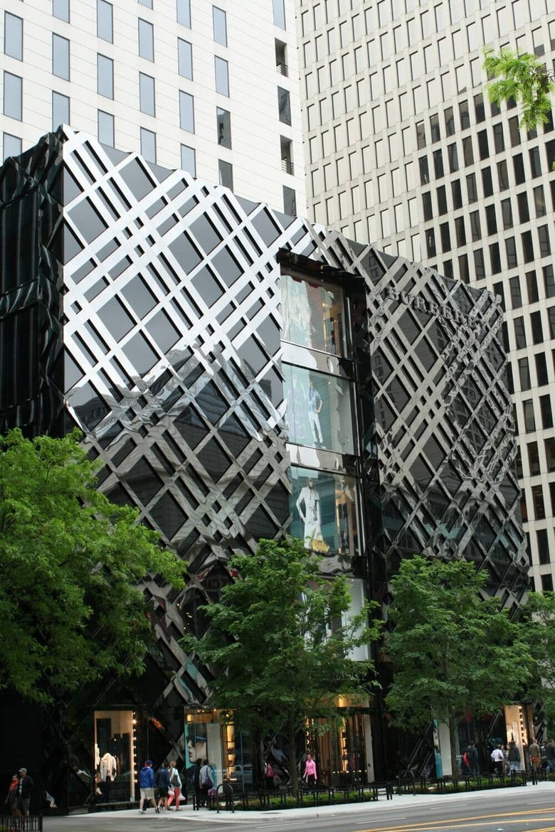 Looking up at large beige building with many windows