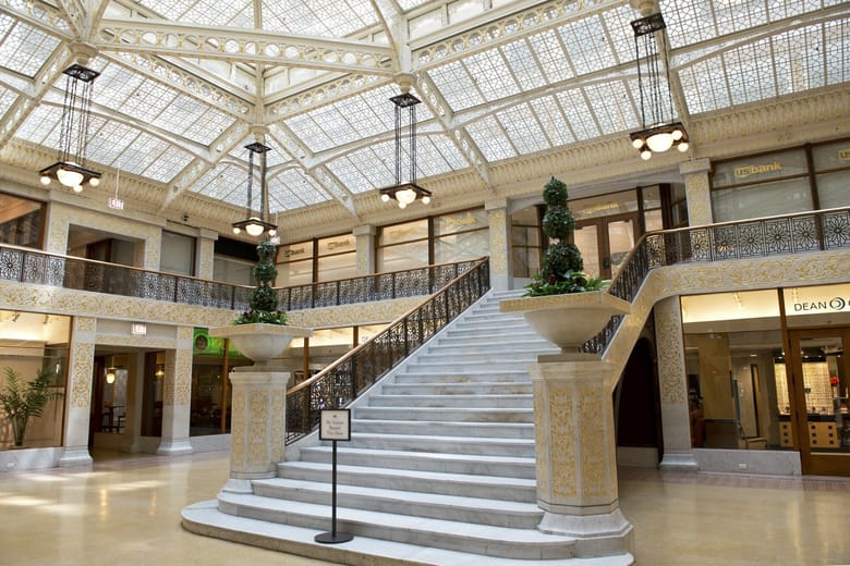 Interior building lobby with glass ceiling and grand staircase