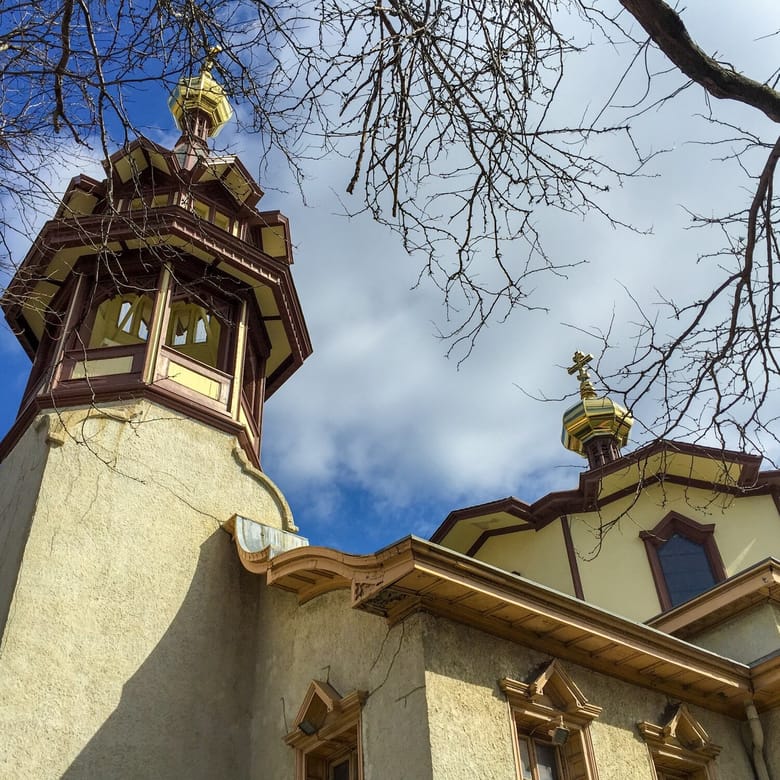 Image of a cream colored tower from below with brown trim.