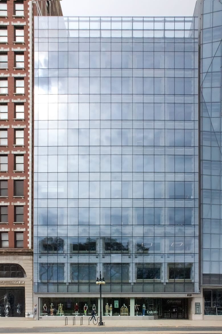 Image of a tall building with a glass facade.
