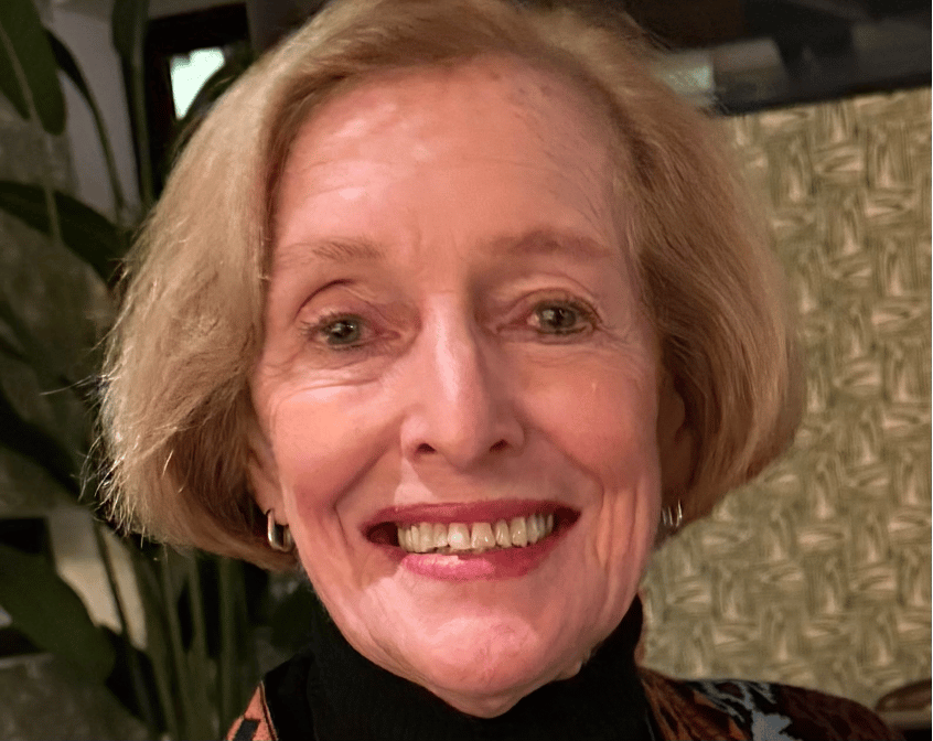 Image of a woman with blonde short hair smiling.